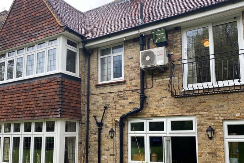 Air conditioning external unit installed on rear of property.