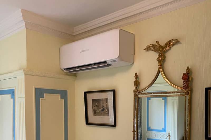 Domestic Mitsubishi air conditioner installed in a bedroom.