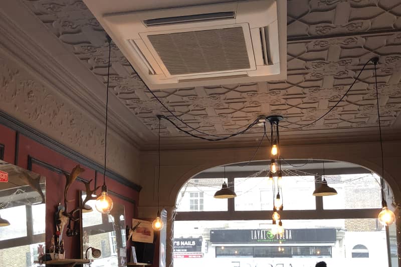 Air conditioning maintenance at a barber shop in London.