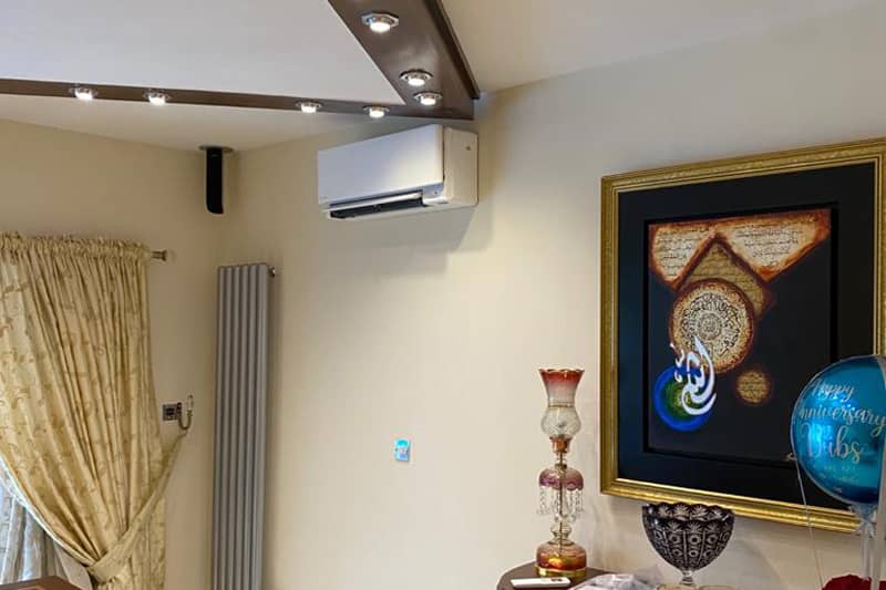 Wall mounted air conditioner installed in a home living room.