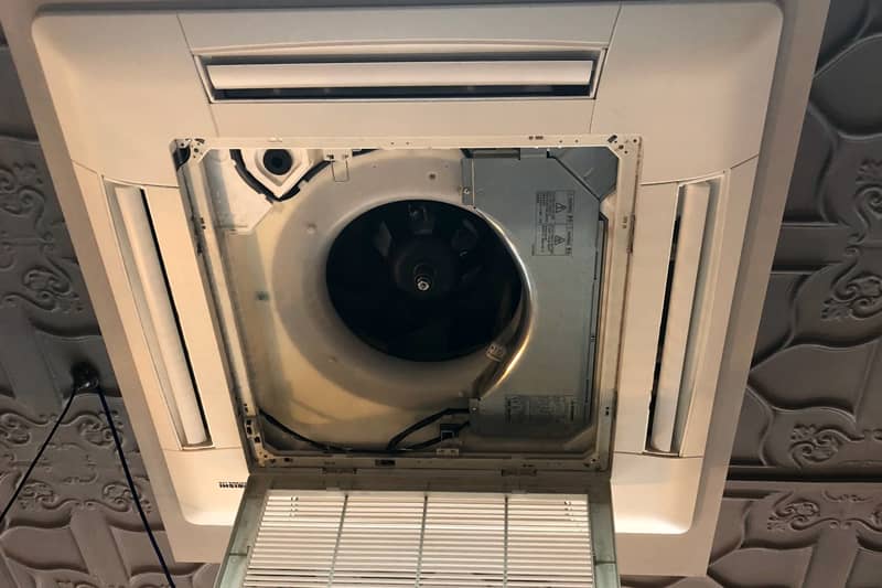 Ceiling air conditioning cassette open during maintenance.