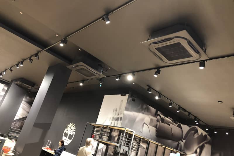 Colour coded ceiling mounted air conditioning cassette in a retail store.