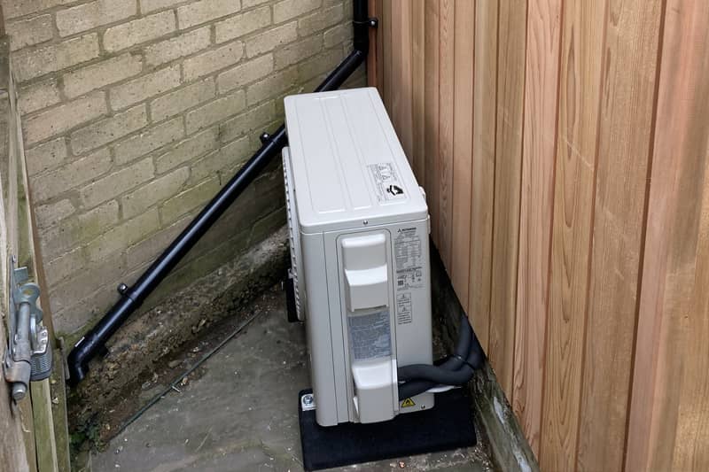 External air conditioning unit tucked away from main sight.