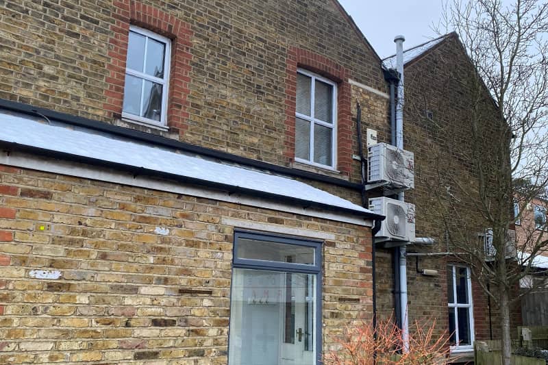External air conditioner units at the rear of a commercial property.