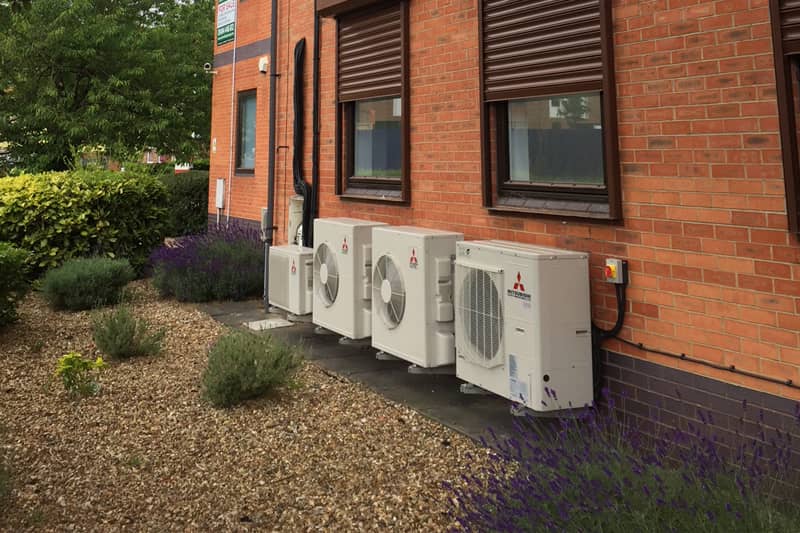 Four external Mitsubishi air conditioning units installed at a domestic property.
