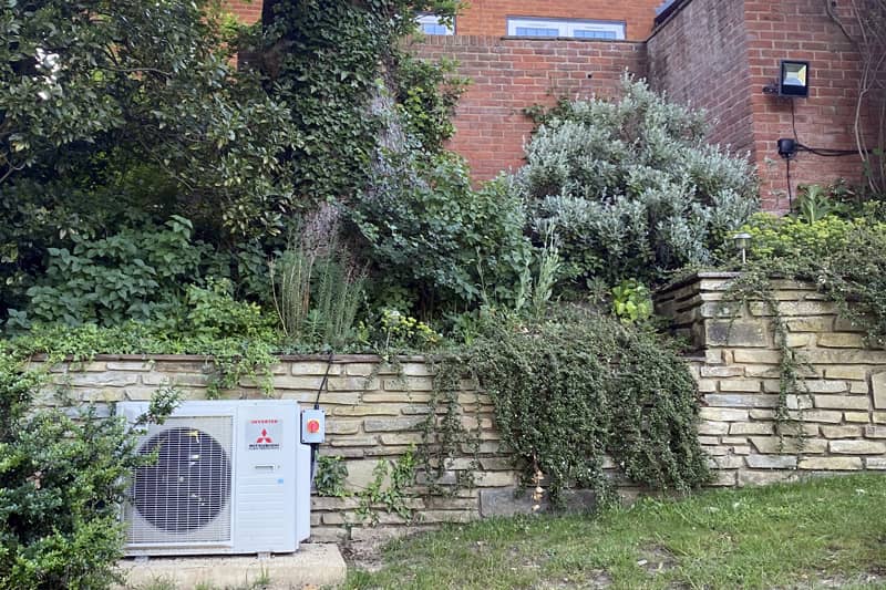 External Mitsubishi unit discreetly installed in the gardern at the rear of a property.