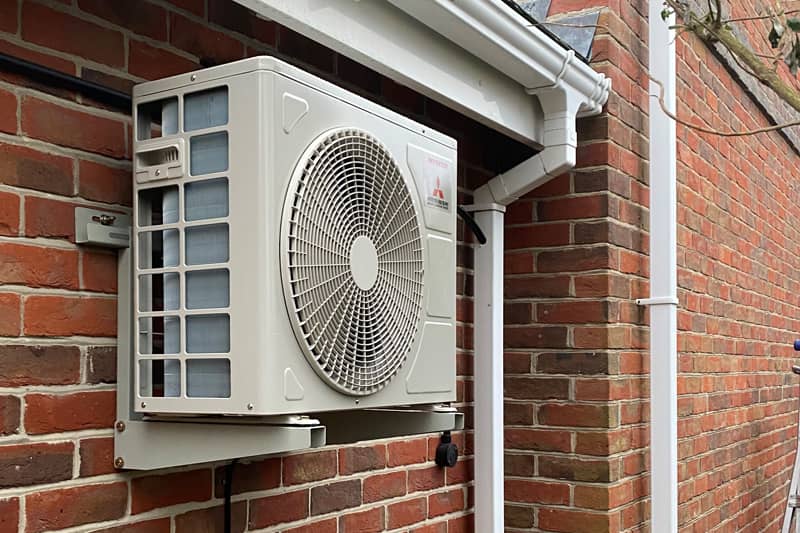 External Mitsubishi air conditioning inverter installed on outer wall.