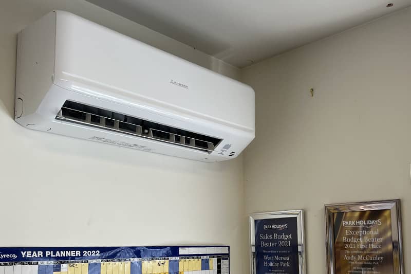 Mitsubishi Air Conditioner mounted on a wall in a home office.