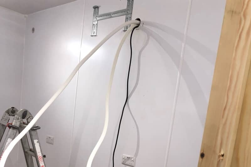 Initial pipework and cables ready for the air conditioner to be installed.