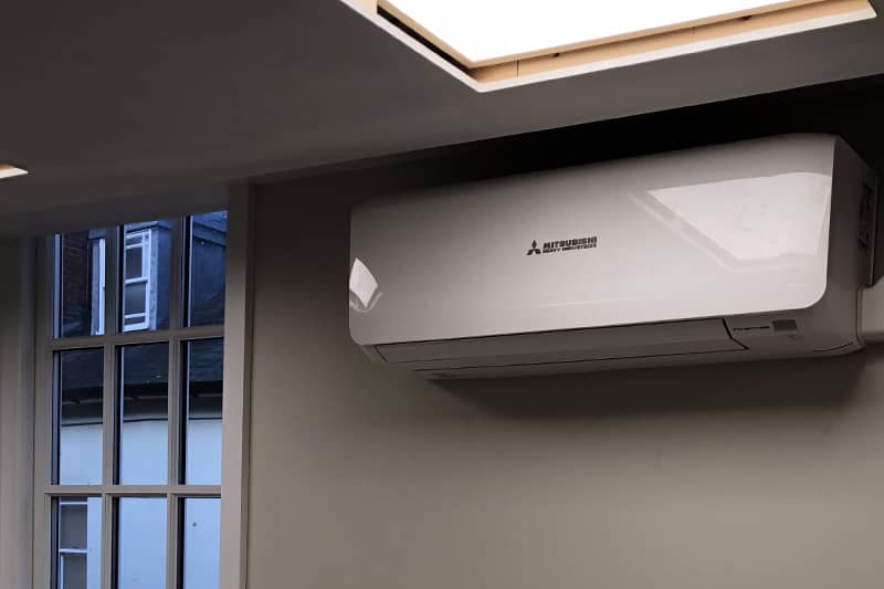 Wall mounted Mitsubishi air conditioner installed in a home office.