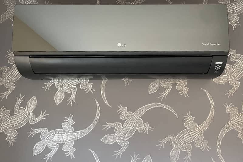 Wall mounted LG Smart Inverter air conditioner installed in a bedroom.