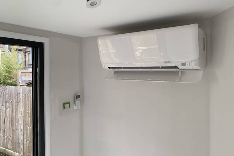 Mitsubishi wall mounted air conditioner with remote.