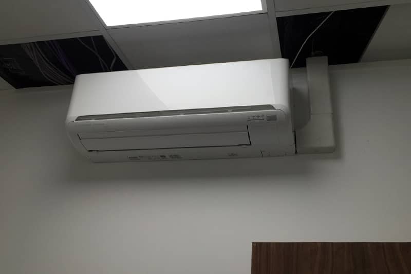 Wall mounted Mitsubishi air conditioner mid installation.