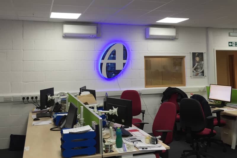 A pair of air conditioners installed in an office.