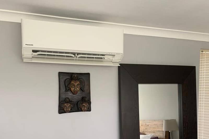 Wall mounted Panasonic Air Purifier installed in a bedroom.