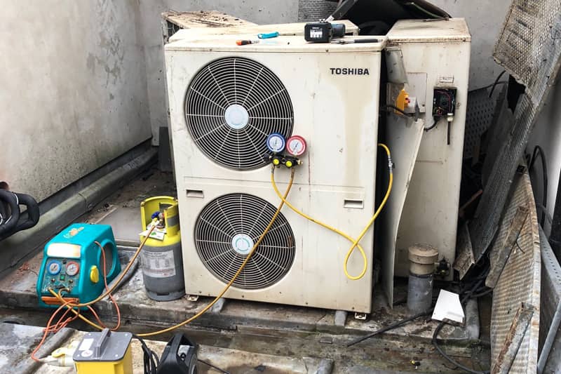 Maintenance test on an external Toshiba air conditioning unit.