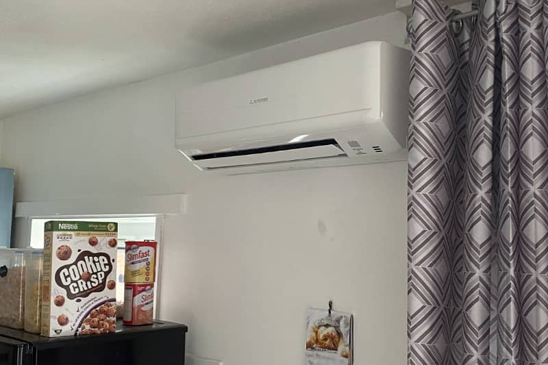 Wall mounted Mitsubishi air conditioner installed in a kitchen.