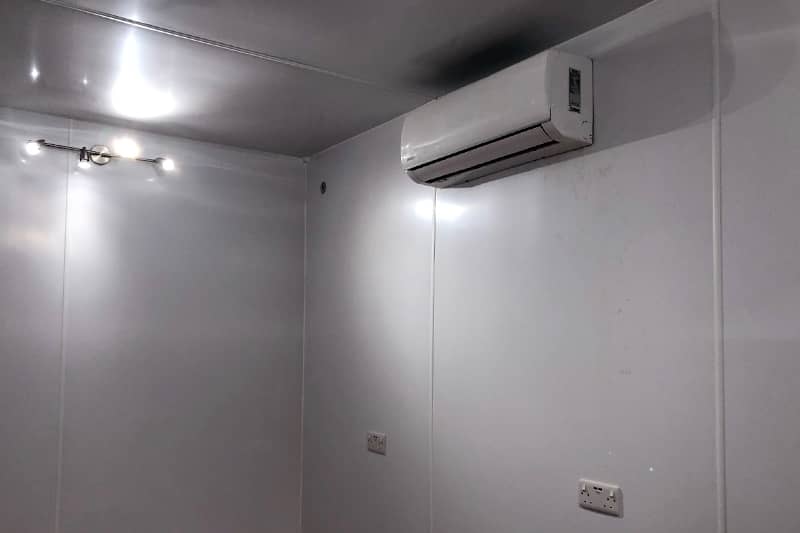 Internal wall mounted air conditioner in a white office.